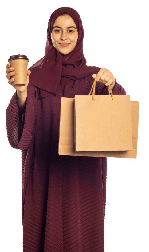Woman holding shopping bags and coffee